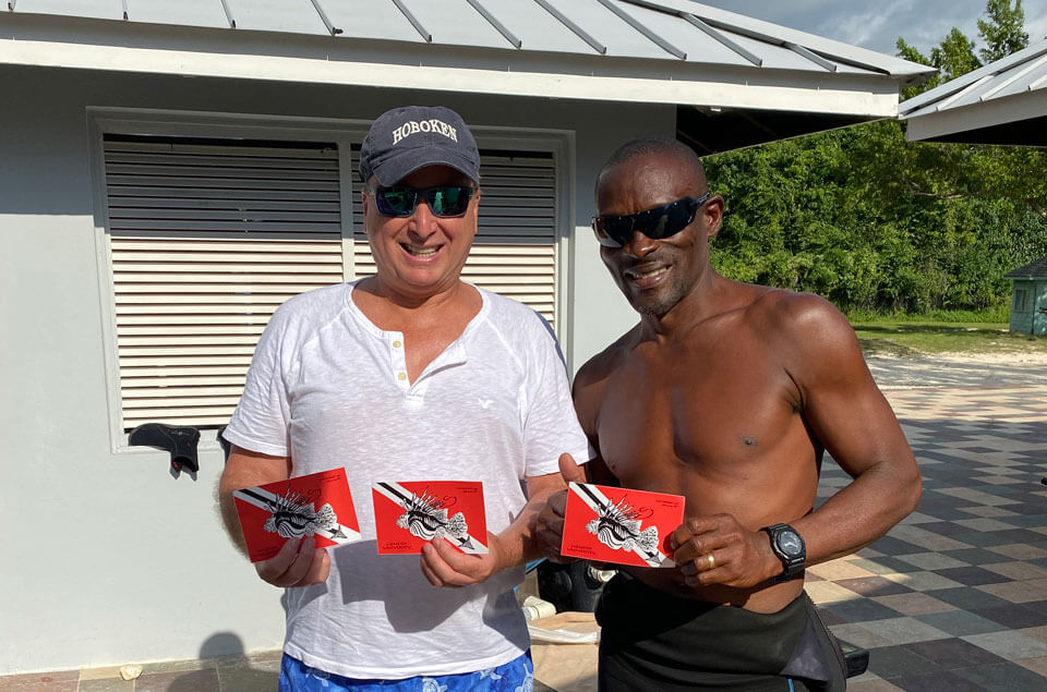 Divers holding Lionfish University stickers