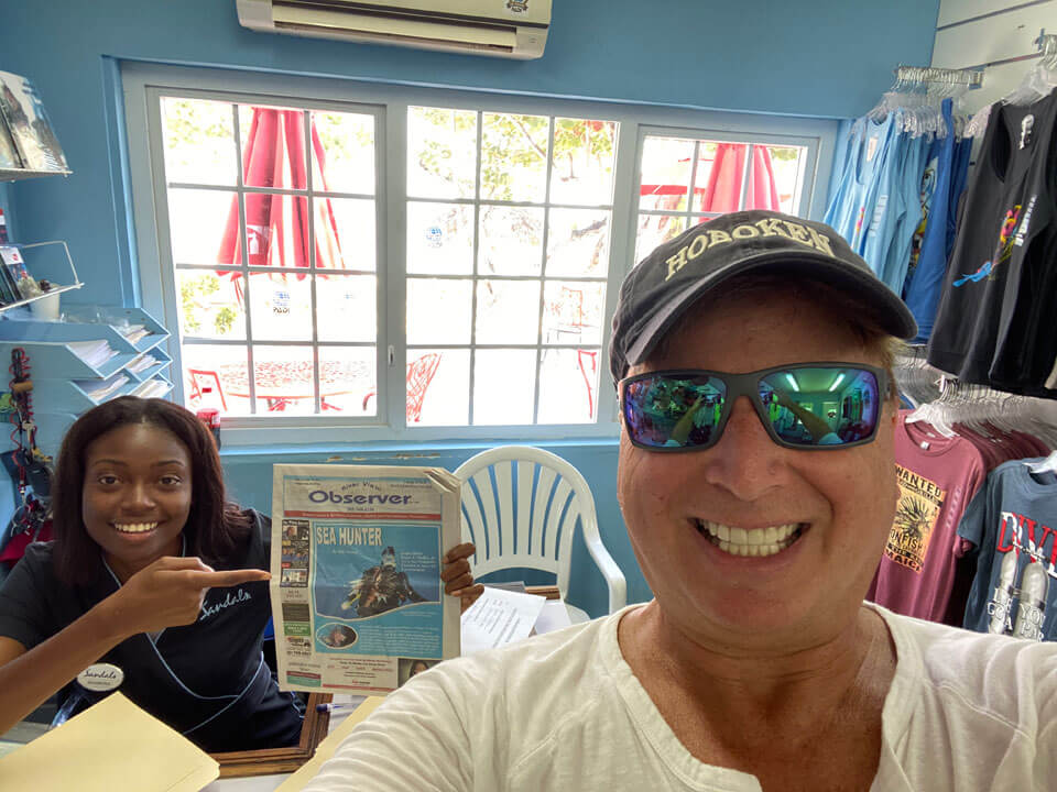 Roger showing article in Jamaican newspaper.