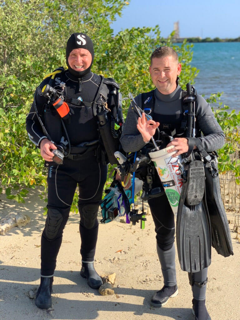 Roger J. Muller, Jr. and Jared Casperson prepare to dive for lionfish