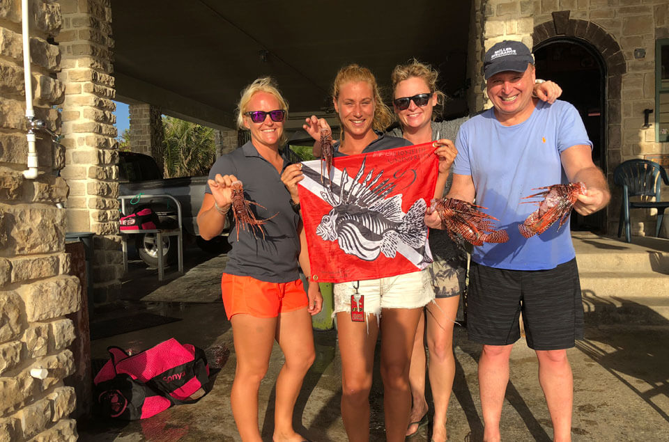 DiveTech staff with lionfish catch