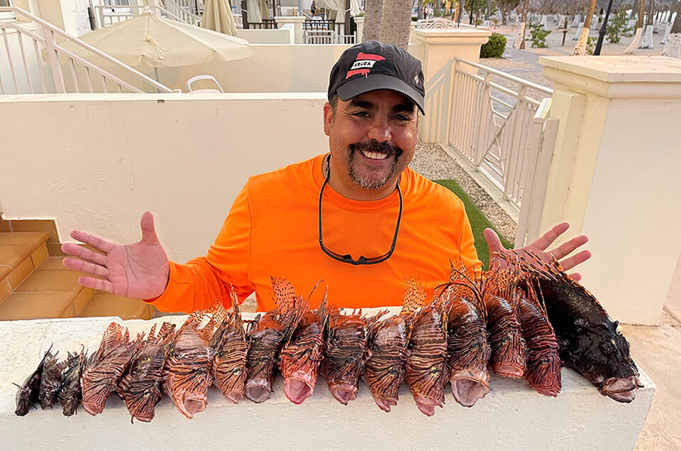Rafael A. Flores Jr. with the lionfish catch of the day