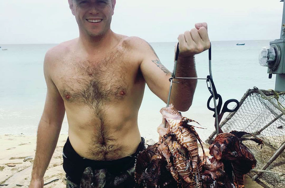 Shad Ferguson holding lionfish catch of the day