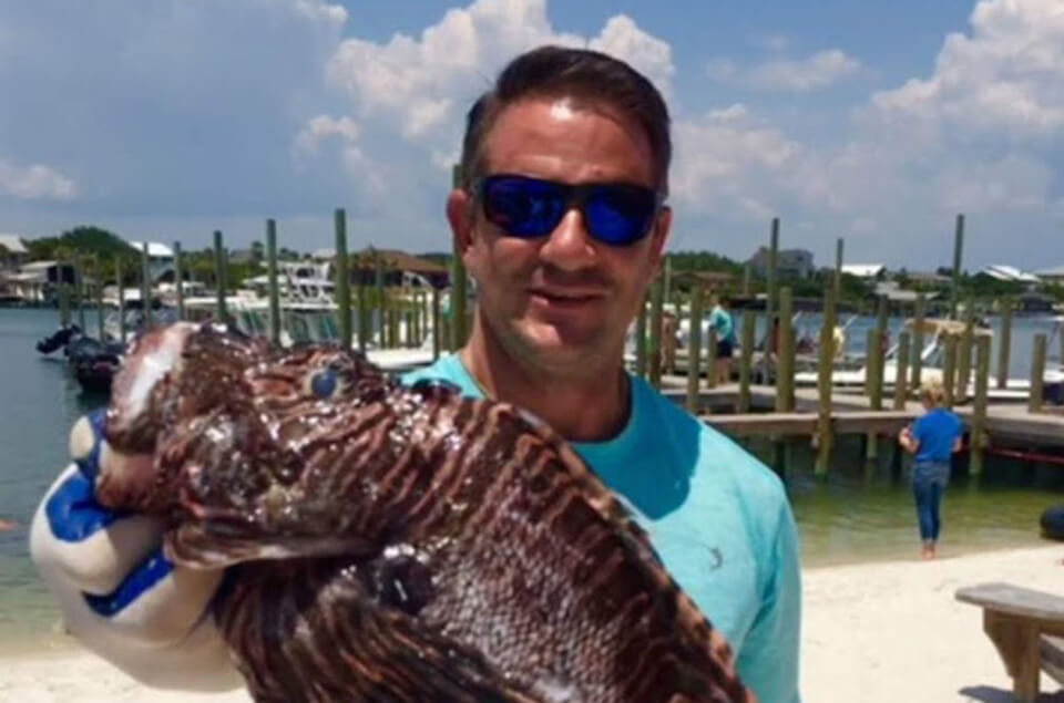 Houston George holding lionfish