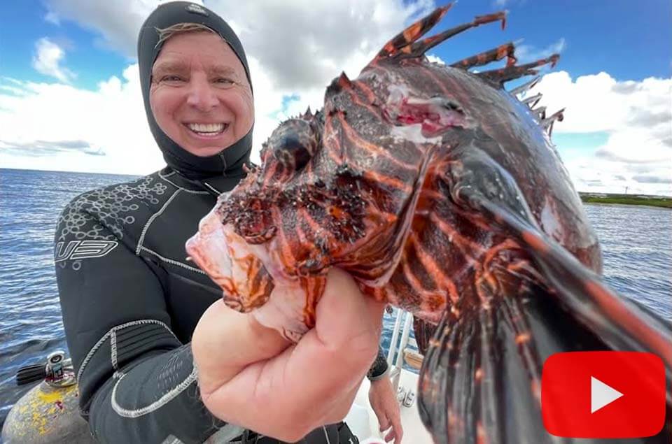 Roger J. Muller, Jr. holding lionfish