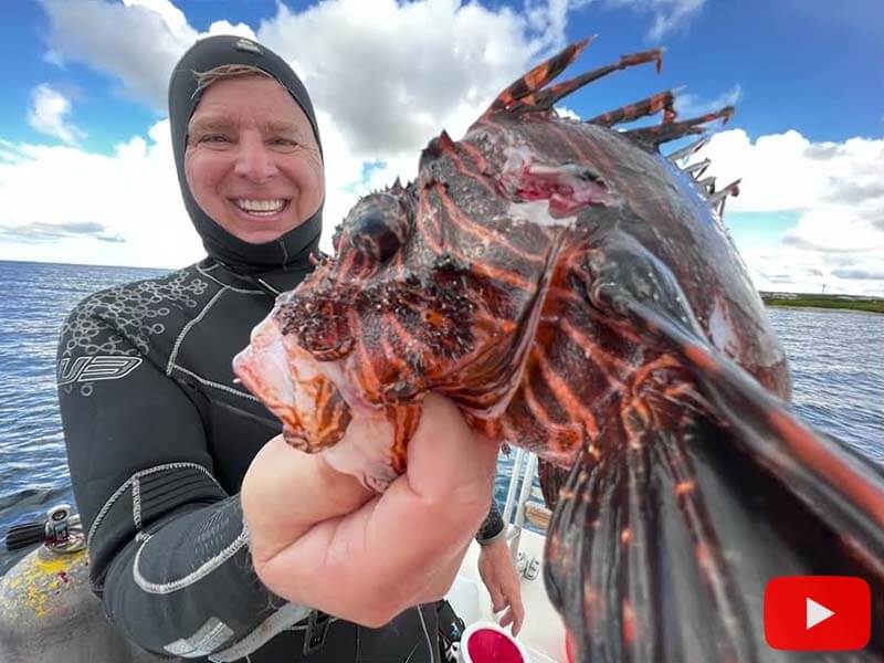 Roger J. Muller, Jr. holding lionfish