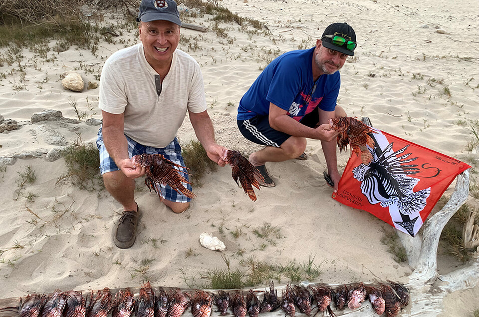 Patrick van Brakel and Roger J.Muller, Jr. with their lionfish catch of the day