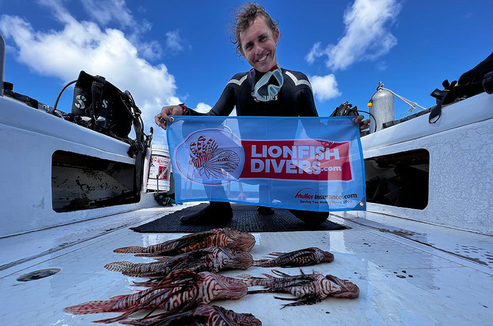 Lukas Moorhead with lionfish catch of the day and lionfishdivers.com