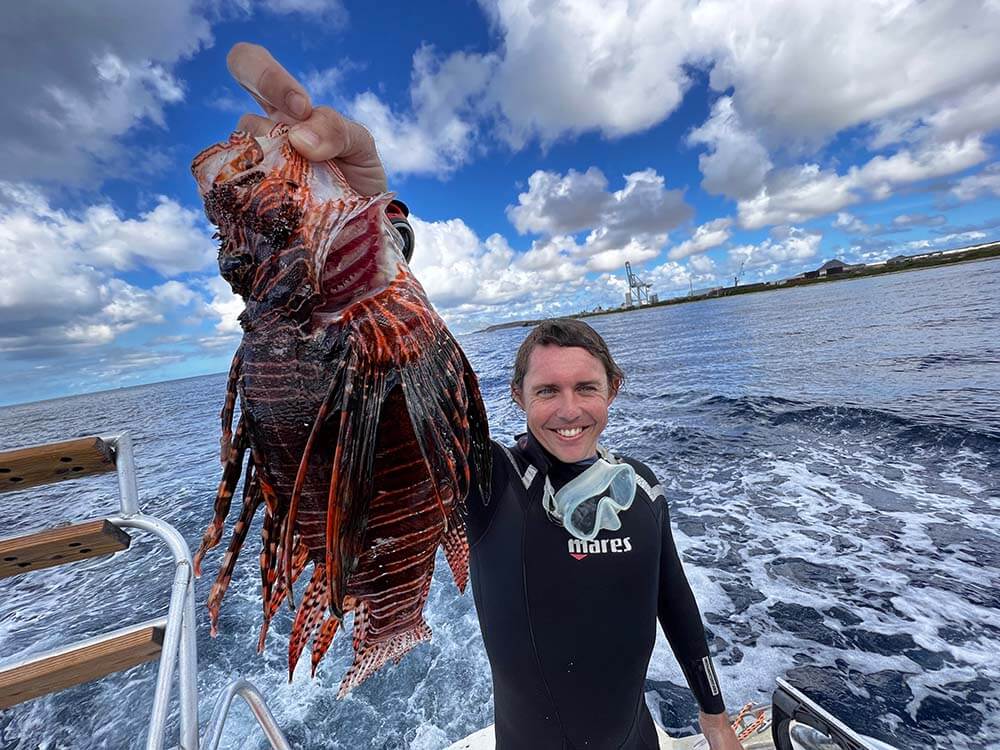 Lukas Moorhead holding huge lionfish in Aruba