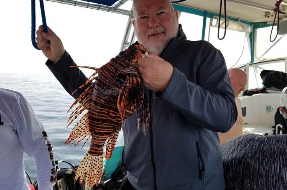 Richard Reysack holding a lionfish