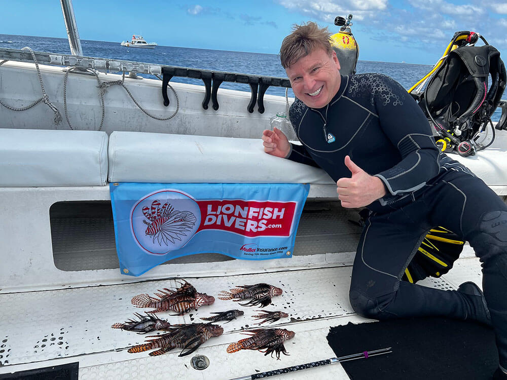 Roger J. Muller, Jr with lionfish catch of the day