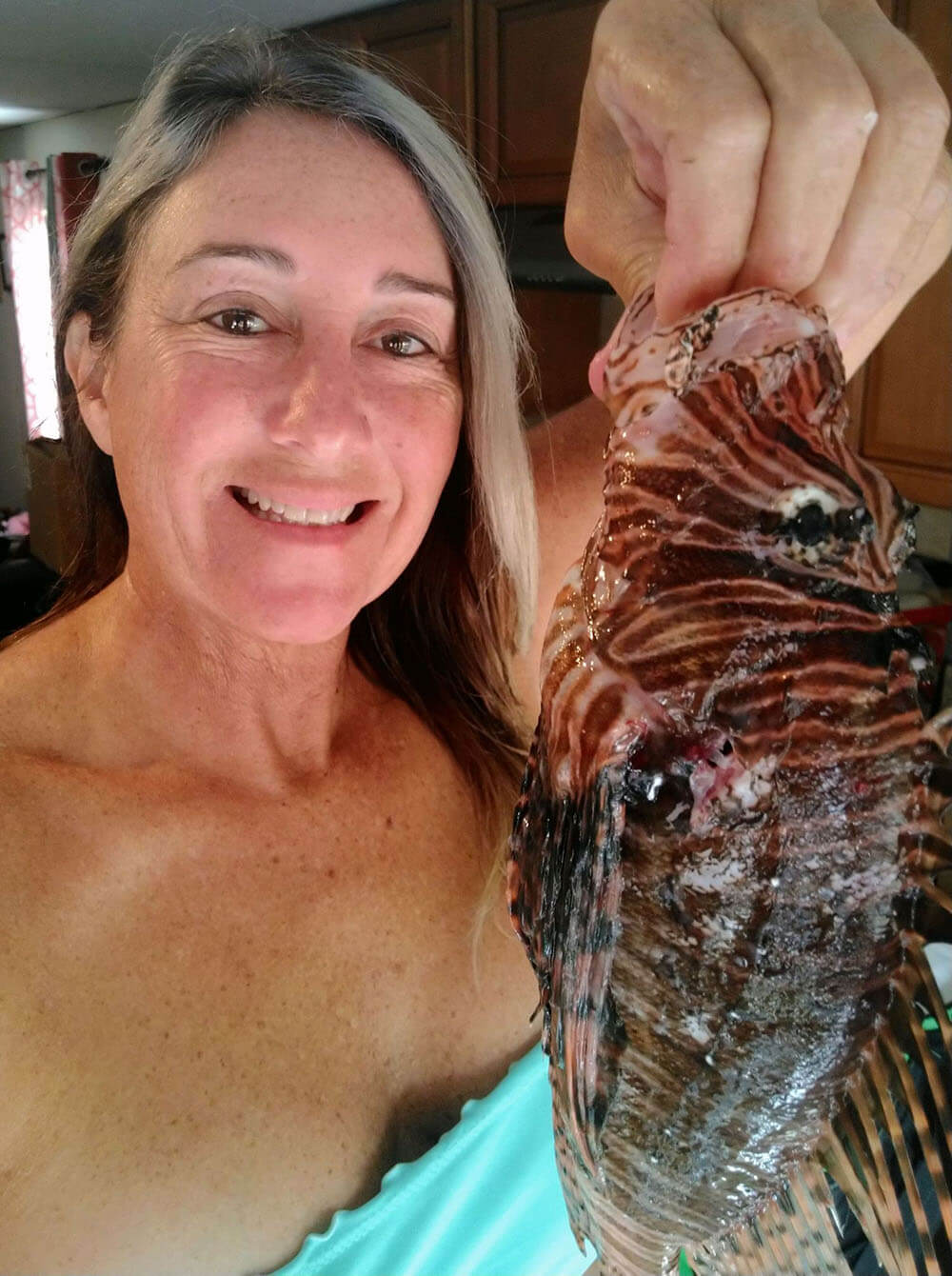 Sherrie Wagner holding a lionfish