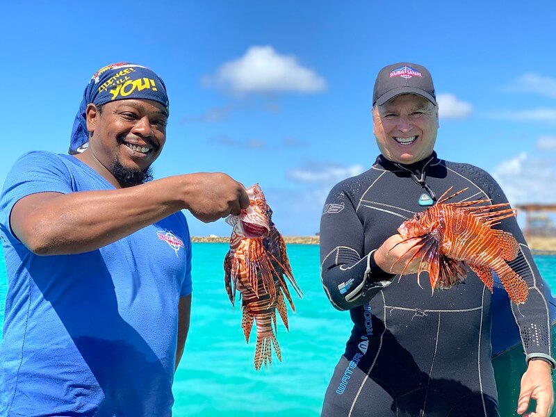 Roger J. Muller, Jr and friend holding lionfish