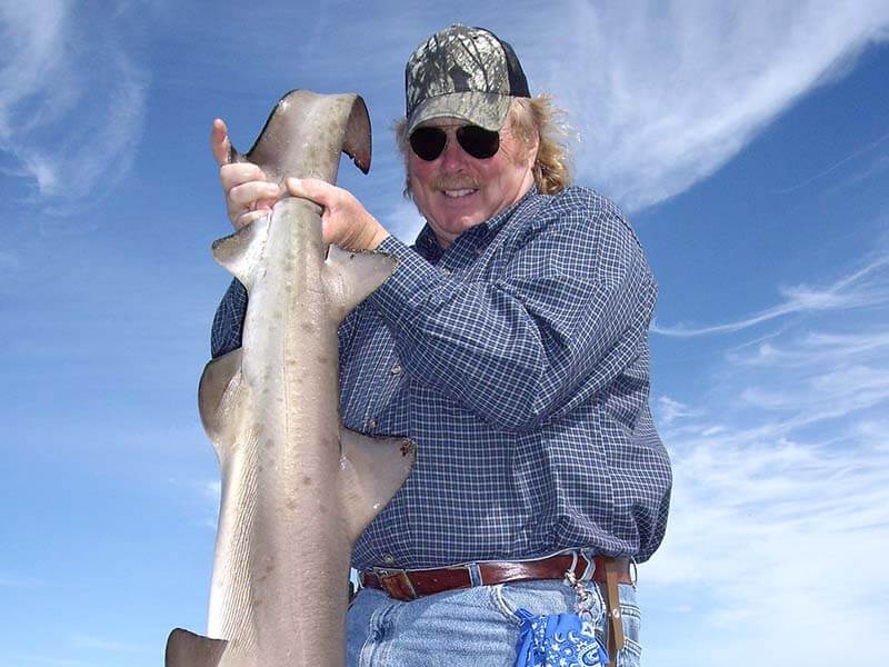 Man holding shark in Cape Cod