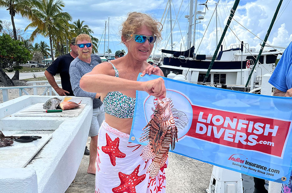 Laura Sudarsky holding a lionfish