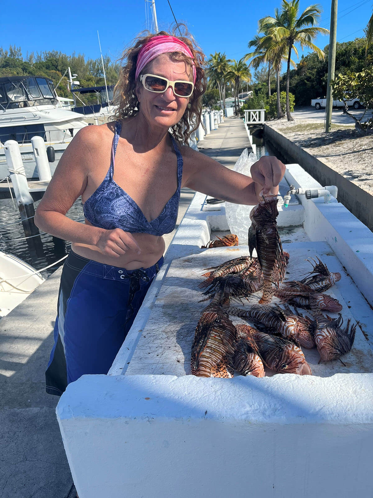 Laura Sudarsky with her lionfish catch of the day