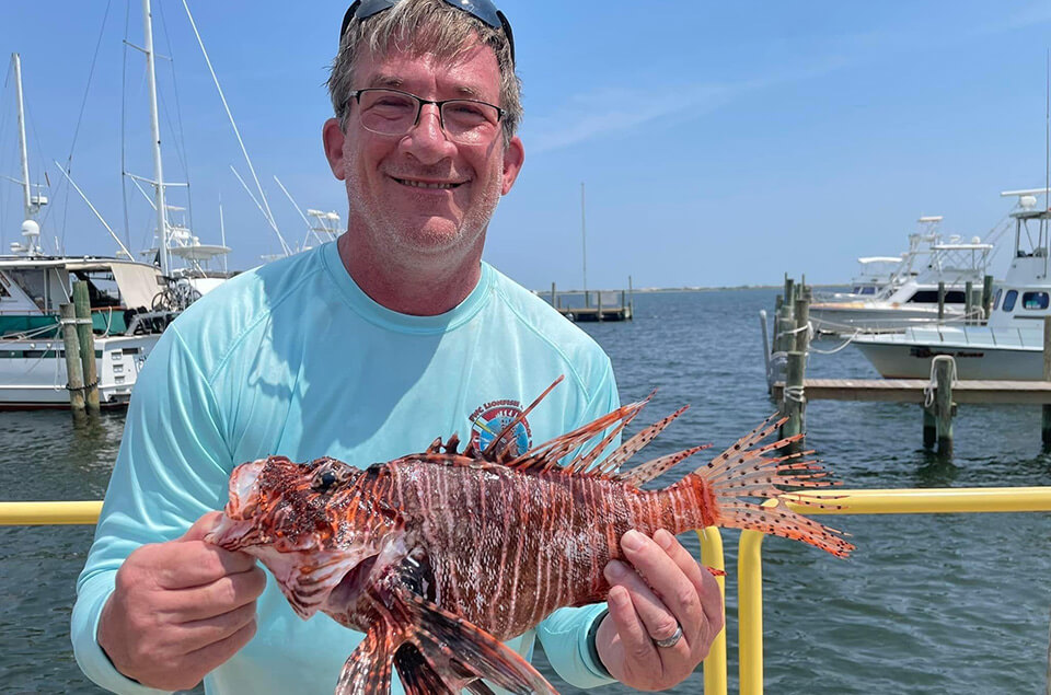 Tom Vyles holding a lionfish