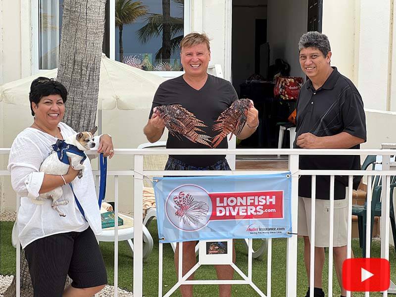 Esmerelda Kock with her husband and Roger J. Muller, Jr. holding 2 lionfish
