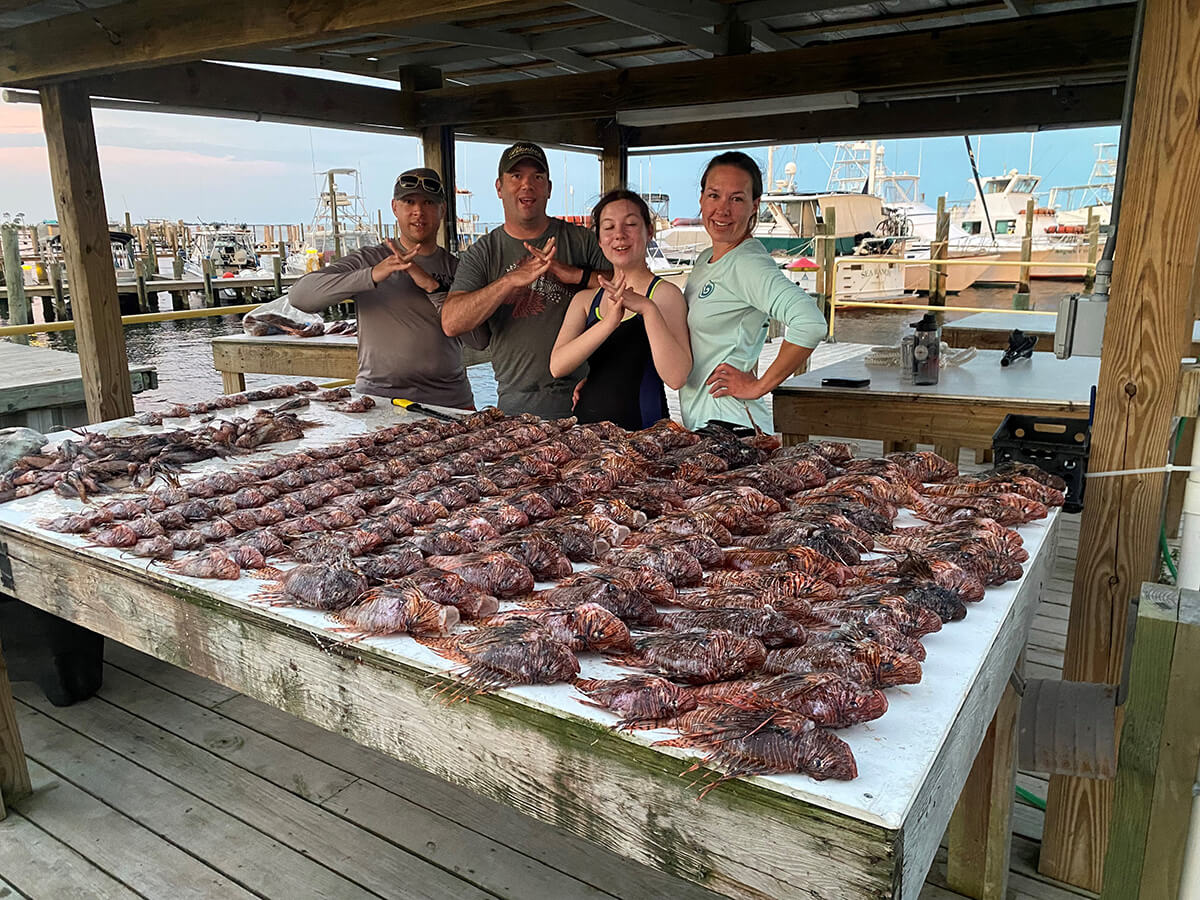Kami Hawks and friends with huge lionfish catch of the day