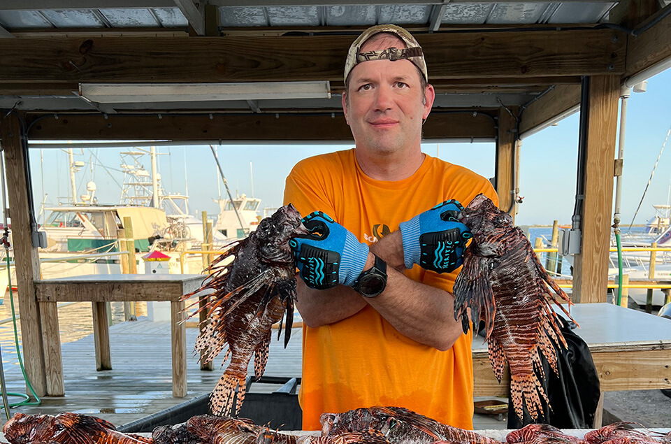 Ryan Hawks with his lionfish catch of the day