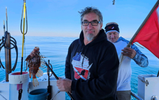 Jamie Doeren holding lionfish on a spear