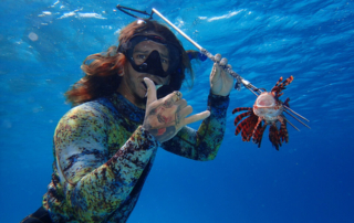Jesus/Coco Maduro with speared lionfish underwater
