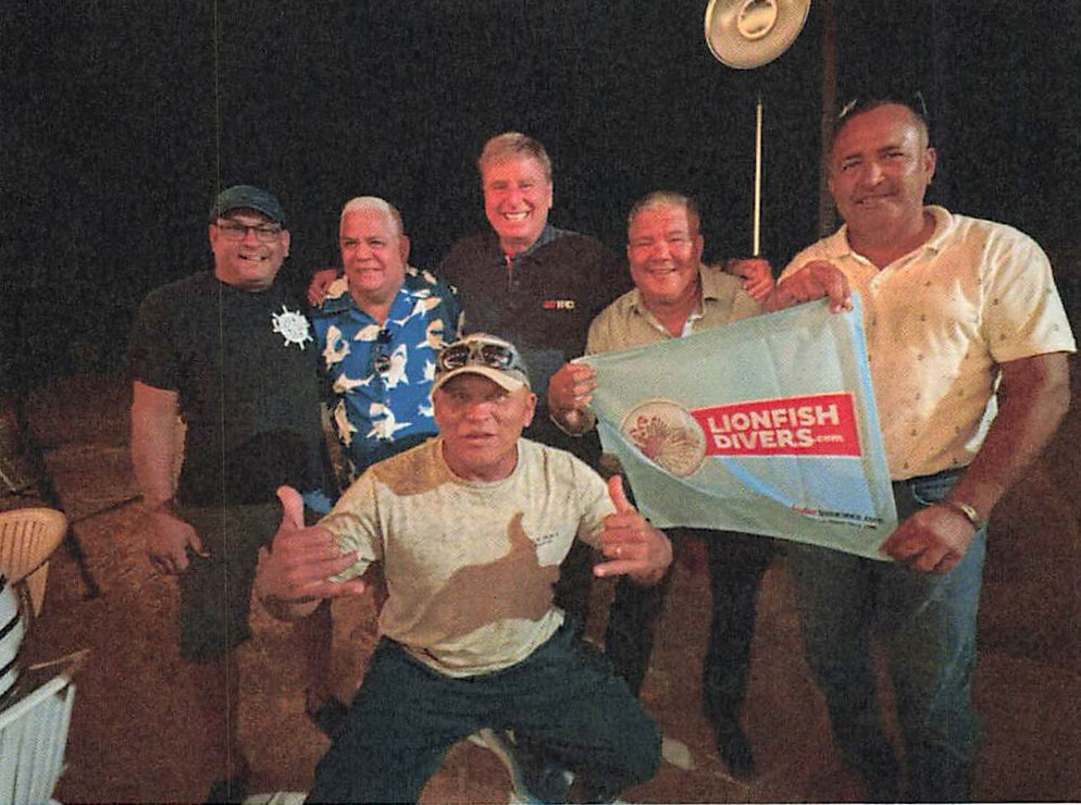 Aruba's lionfish hunters with the Lionfish Divers banner