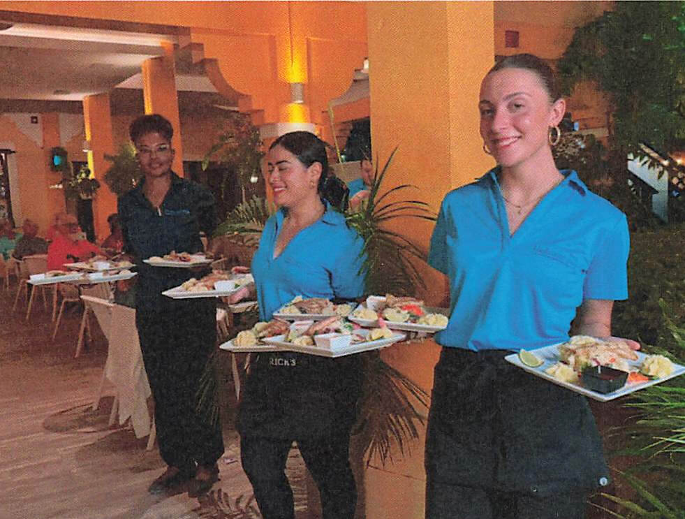 Hadicurari staff serving freshly prepared lionfish dishes